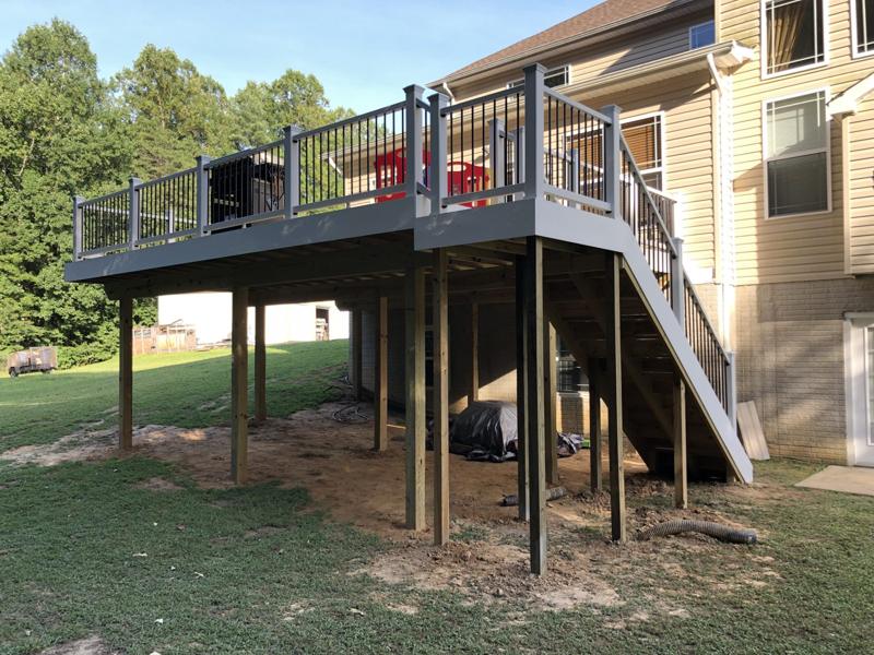 An elevated deck with a full stair run on a sloped lot