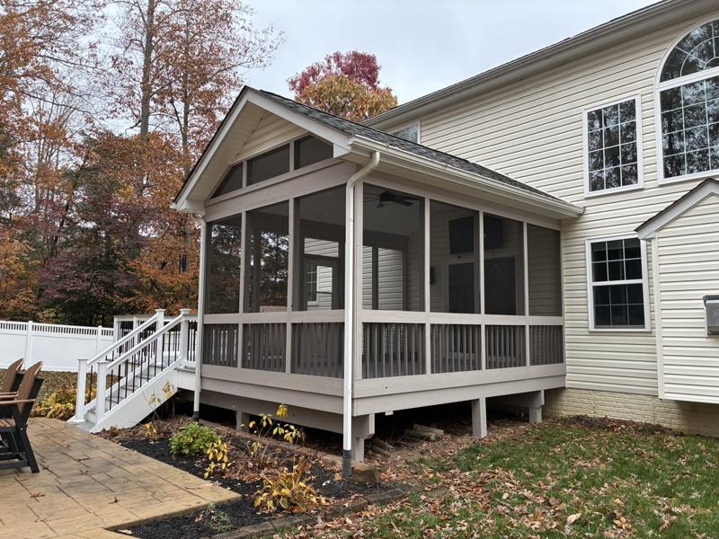 A screened porch and deck addition in fall